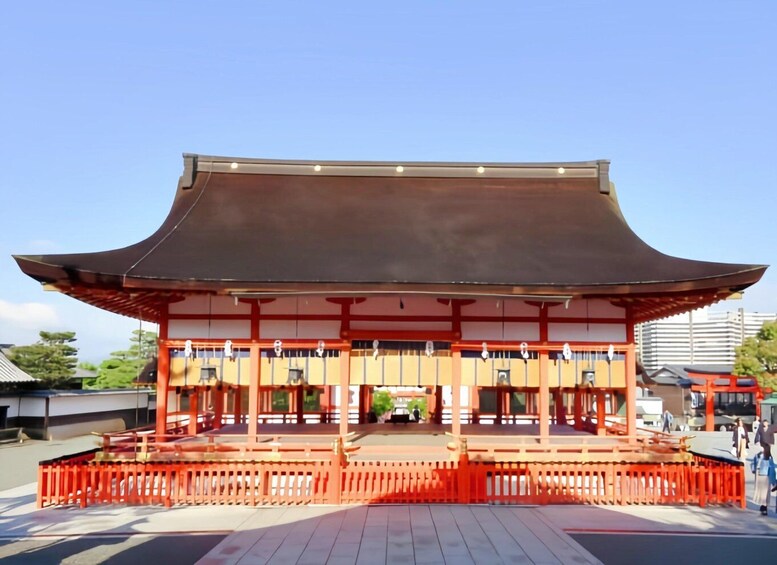 A traditional Japanese building with a curved roof and red pillars. 2