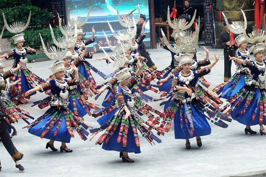 A group of dancers in traditional costumes performing a dance. 1