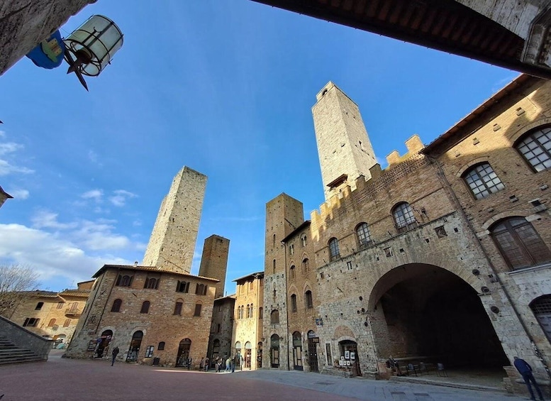 A historic stone building with tall towers and an arched entrance. 3