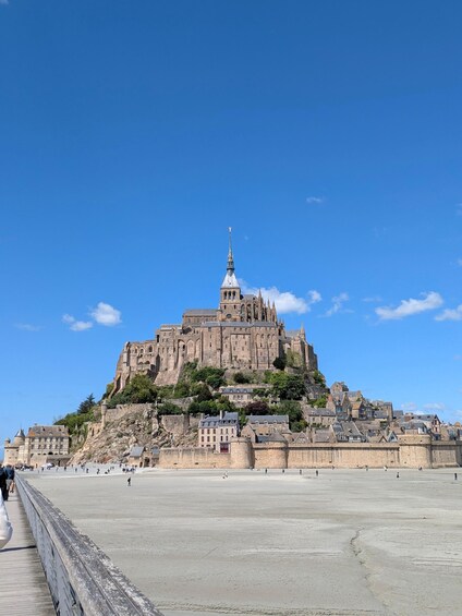 A historic castle on a hill with a clear sky. 1