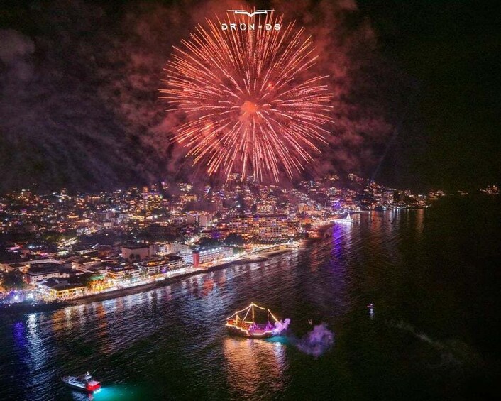 A cityscape at night with fireworks over the water. 1