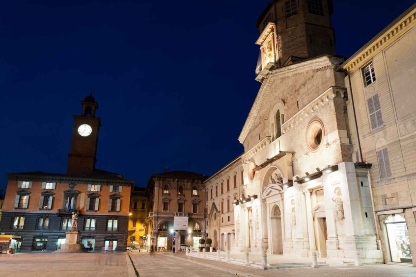 A historic square with a clock tower and a church with ornate architecture. 3
