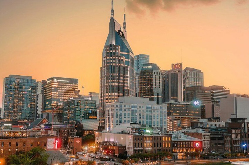 A city skyline with modern buildings and a prominent tower. 2