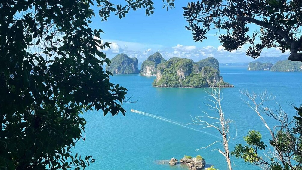 A coastal landscape with clear blue waters, a small island, and surrounding cliffs. 2