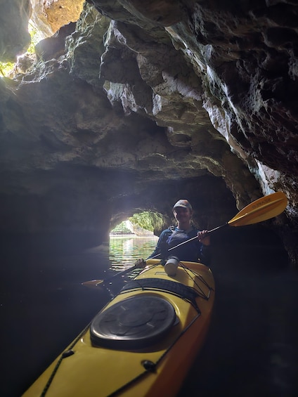 A person kayaking in a cave. 5