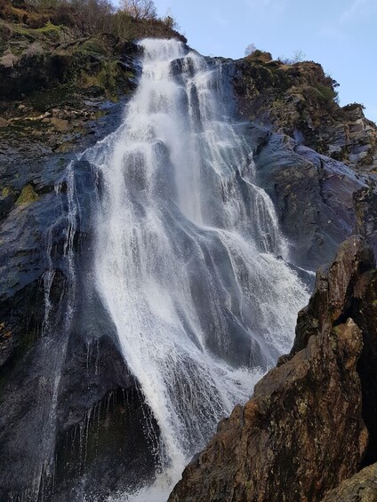 A waterfall cascading over rocky terrain. 3