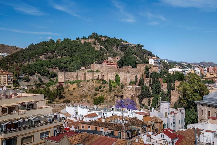 A historic hilltop fortress with surrounding modern buildings. 3