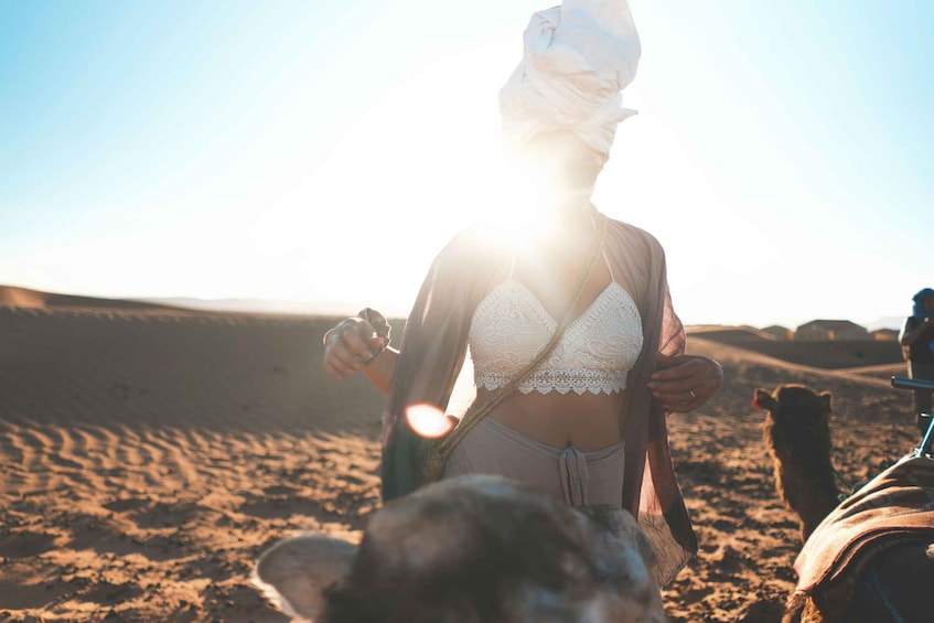 A person riding a camel in a desert landscape. 5
