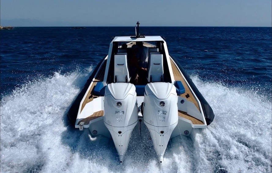 A speedboat with dual outboard motors on a clear day. 3