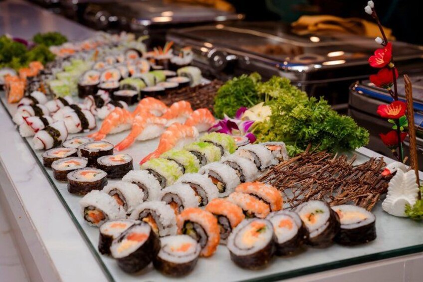 A variety of sushi on a glass display. 2