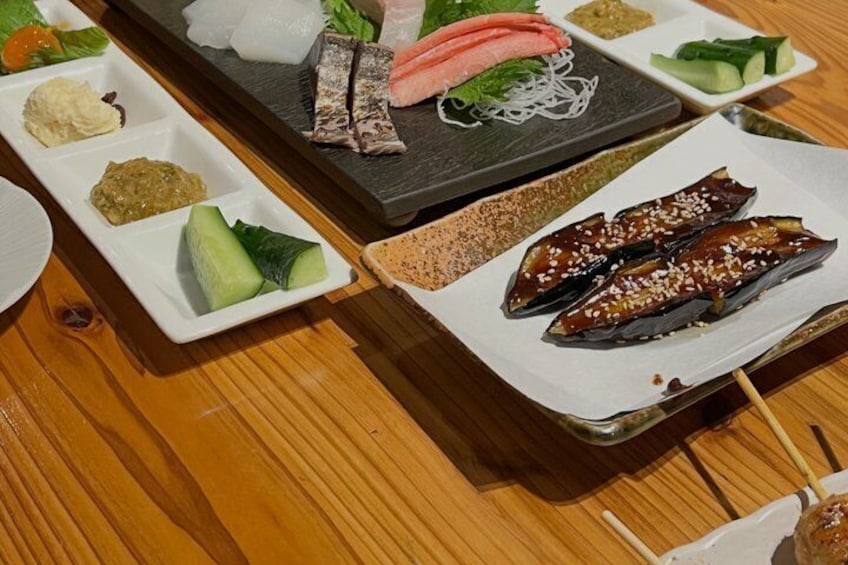 A variety of sushi dishes on a wooden table. 4