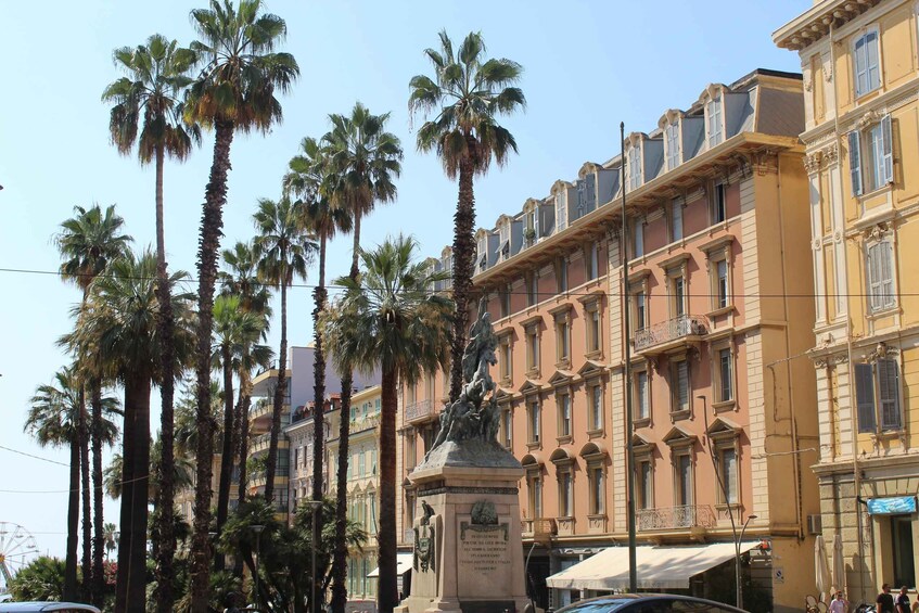 A street lined with palm trees and historic buildings. 2