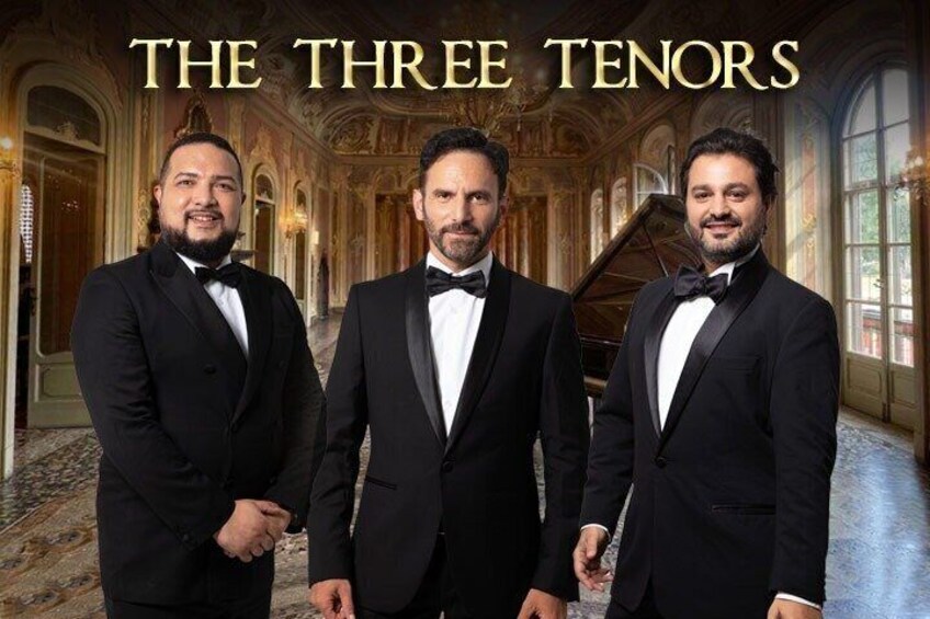 Three men in black suits in a grand hallway with ornate decorations and a grand piano. 1