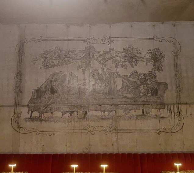 A detailed mural with a tree, figures, and a bench. 4