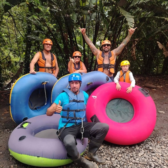 People with inflatable tubes in a forested area. 3