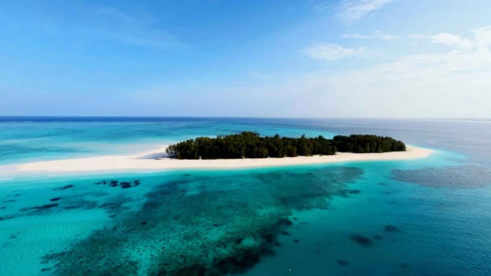 A tropical island surrounded by turquoise waters. 1