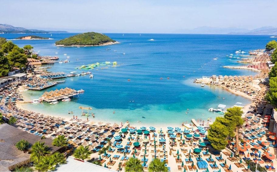 A coastal resort with a beach, umbrellas, and boats. 2