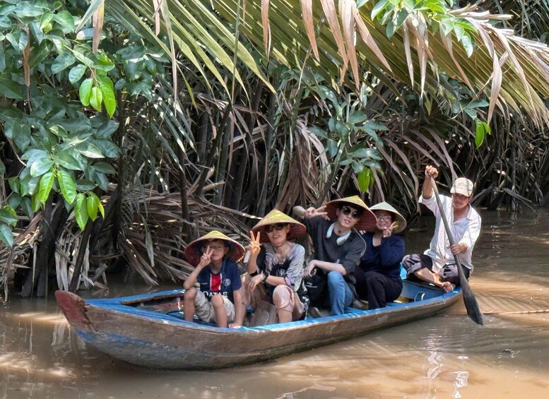 A group of people in a boat surrounded by dense mangrove vegetation. 5