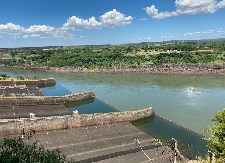 A dam with multiple spillways and a river. 1