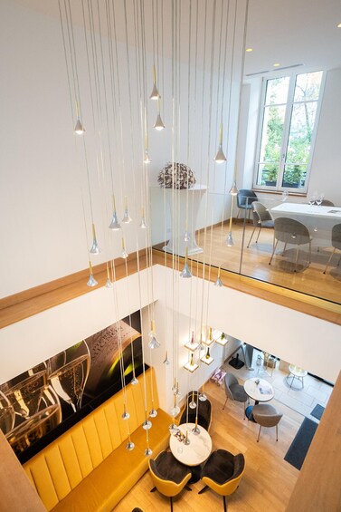 A modern interior with a dining area, hanging light fixtures, and a view of the outdoors. 3