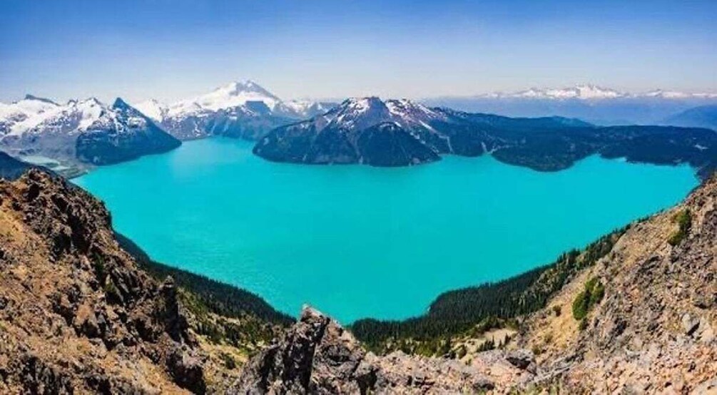 A turquoise lake surrounded by mountains. 1