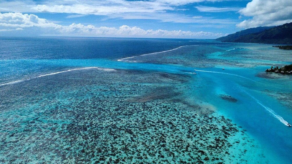A tropical island with clear turquoise waters and a white sandy beach. 2