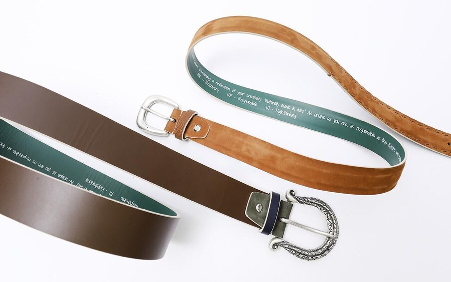 Three leather straps with metal buckles and engraved text. 5
