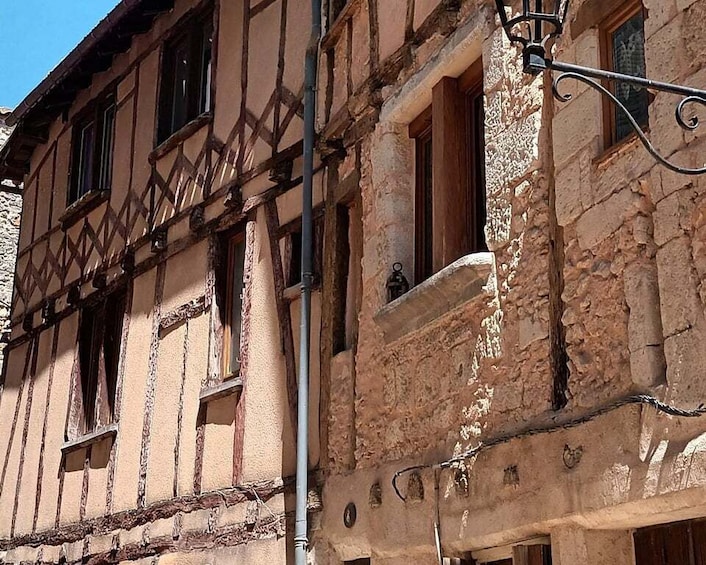 A half-timbered building with exposed wooden beams and a stone facade. 2