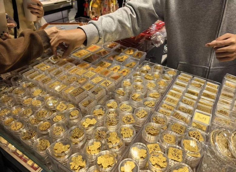 A display of gold coins in clear plastic containers. 2