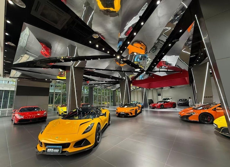 A showroom with multiple sports cars, including a prominent yellow one in the foreground. 1