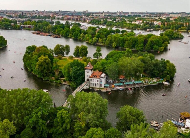 A river with boats, a bridge, and a park with trees. 3