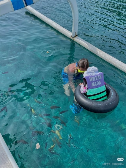 A person snorkeling in a pool with a life vest labeled 'WAYAN NADRA.' 4