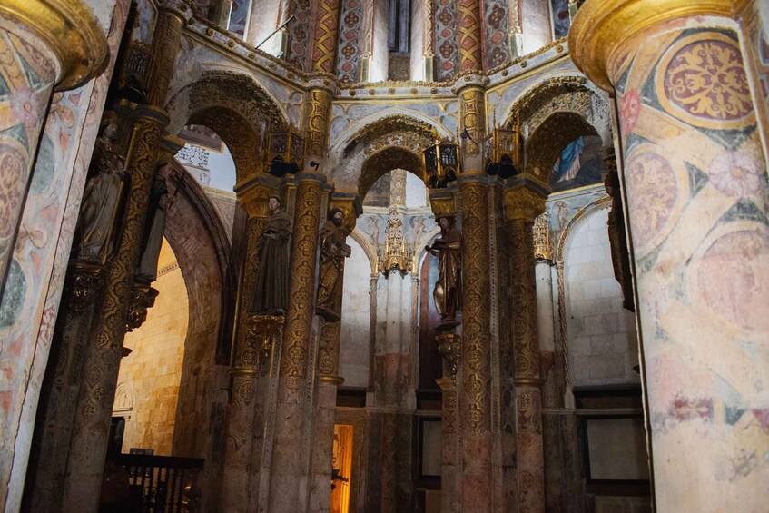 An ornate church interior with detailed frescoes and gold accents. 2