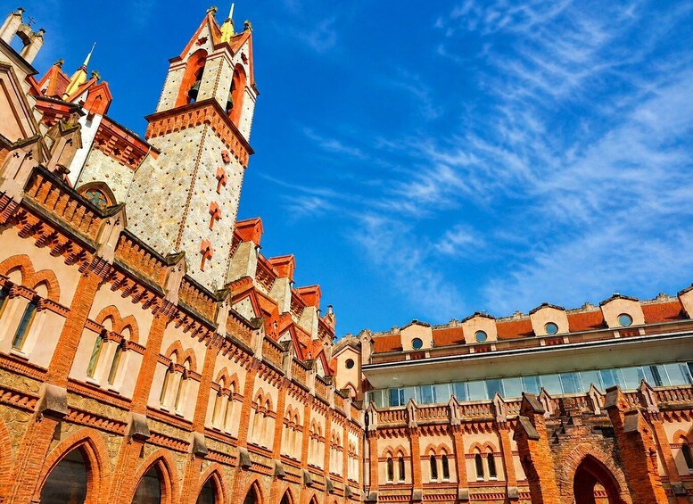 A historic building with intricate brickwork and a prominent tower. 5