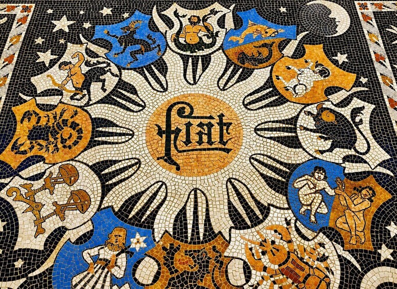 A detailed mosaic with a central emblem surrounded by various figures and symbols. 2