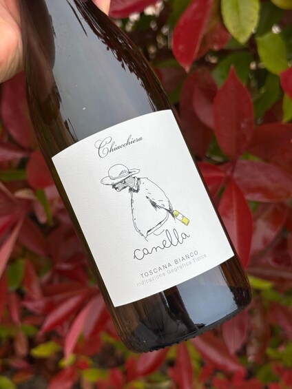 A bottle of Chiacchiera Camella wine with a label featuring a drawing of a person and text. 4