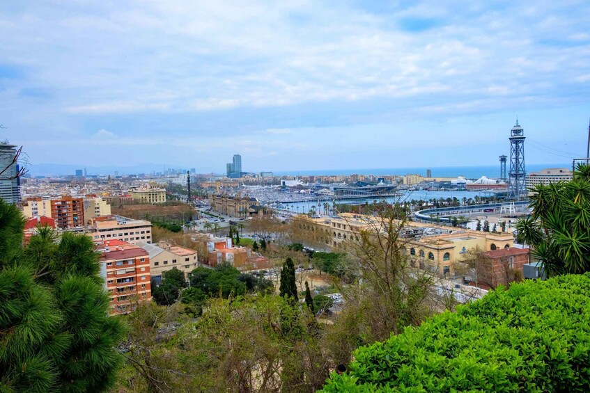 A coastal cityscape with a prominent tower, a marina, and a mix of residential and commercial buildings. 5