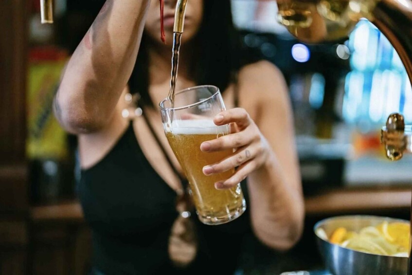 A person pouring a beer into a glass. 4