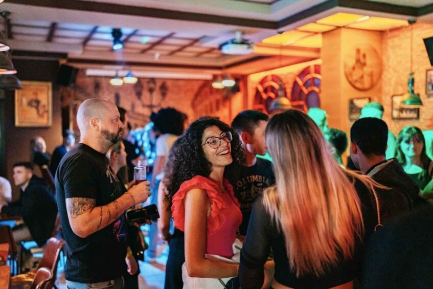 A crowded bar with people socializing. 3
