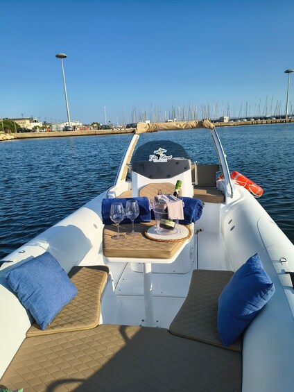 A boat with a table set for two, glasses, and a bottle of champagne. 4