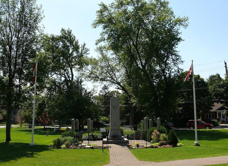 A memorial with a central monument, surrounded by trees and a well-maintained lawn. 5