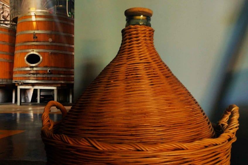 A woven basket with handles, a metal barrel, and a circular opening. 3