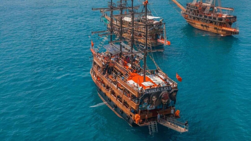 A large ship with a superstructure and multiple decks, floating on a body of water. 5