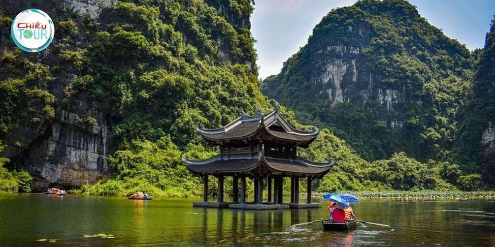A traditional Chinese pavilion on a river, surrounded by lush greenery and rocky cliffs. 1