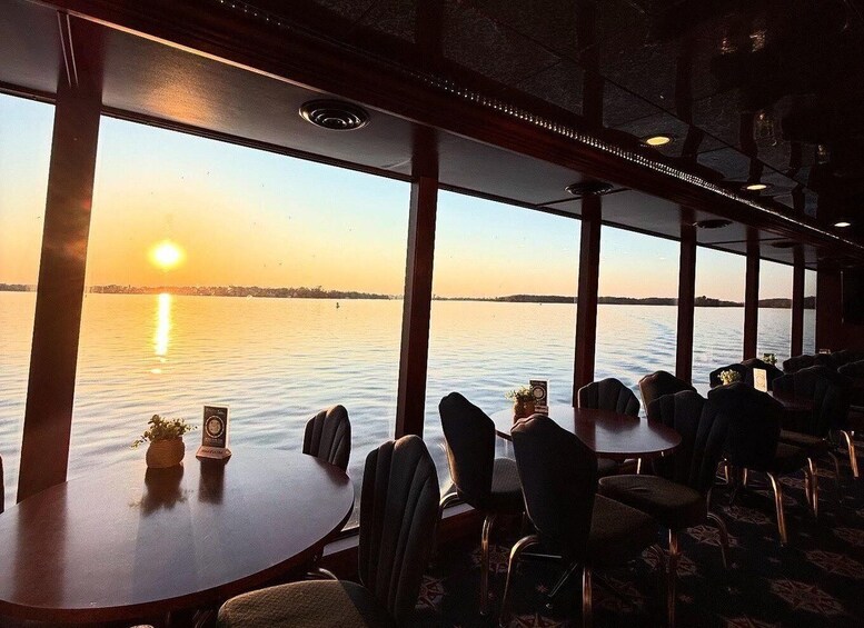 A restaurant with a view of a sunset over water. 5