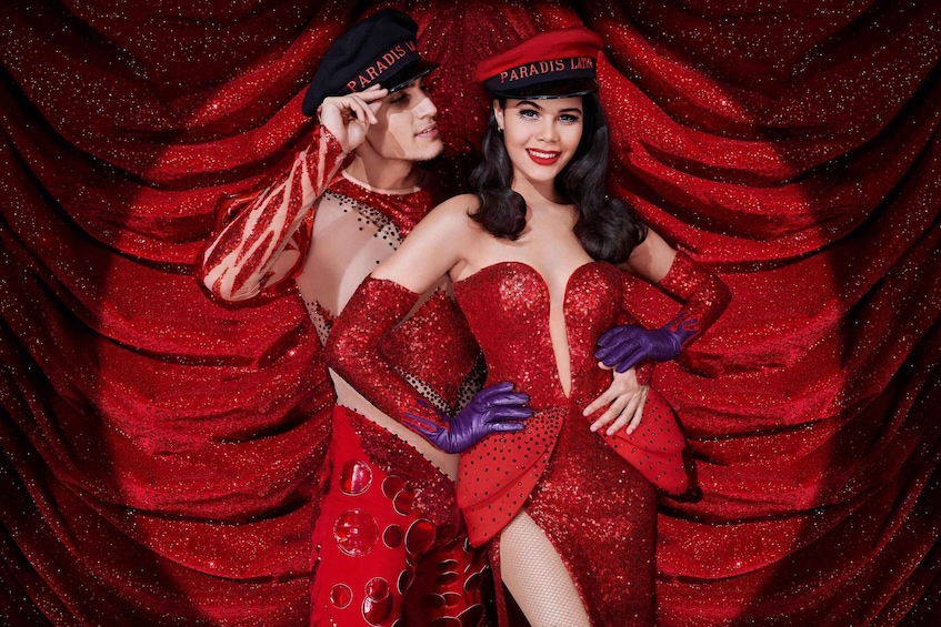 Two people in red glittery costumes with 'PARADIS L'ATLANTIQUE' hats. 3