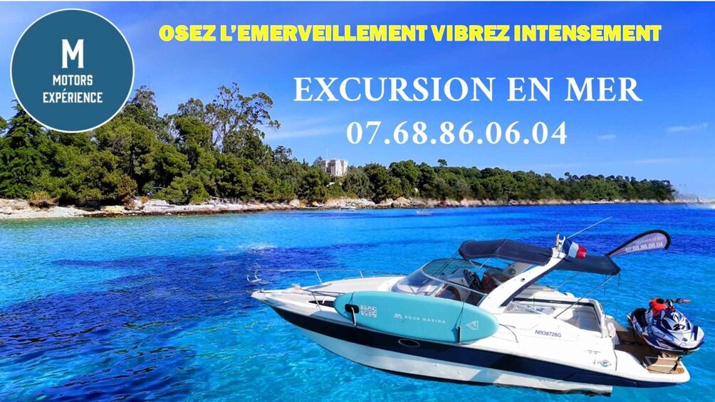 A boat on clear blue water with a coastal landscape in the background. 2