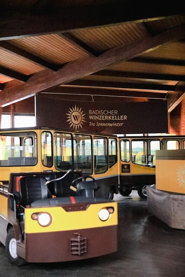 Vintage buses parked inside a building with a sign reading 'BADISCHER WINZERKELLER.' 3