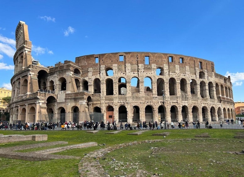 The Colosseum in Rome with tourists around. 1