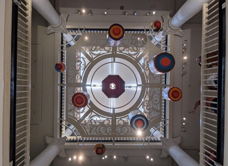 A ceiling with a central circular design surrounded by decorative elements and lights. 4